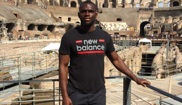 Victor standing in the Colosseum are in the background